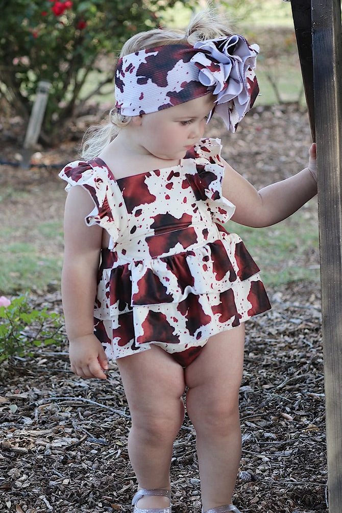 MULTI- COW SPOTTED PRINT BABY ONESIE W/ SNAPS.