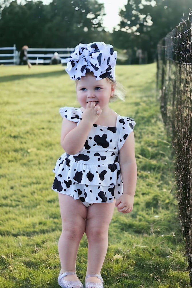 MULTI- COW SPOTTED PRINT BABY ONESIE W/ SNAPS.